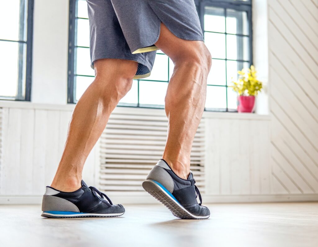 Man's legs in fitness shoes.