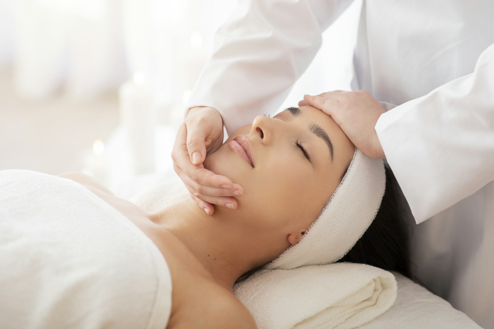 Masseuse Lady Making Face Lifting Massage To Indian Woman In Spa Salon